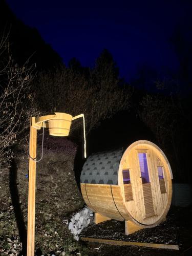 a small tree house with a light on it at Chalet Ai Grecc in Mezzolago