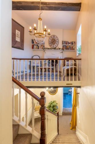 a staircase in a house with a clock on the wall at Harmony House Boutique B&B in Stillingfleet