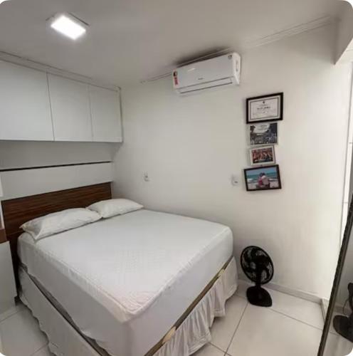 a small white bedroom with a bed in it at Casa de Praia na Barra, Ilhéus in Ilhéus