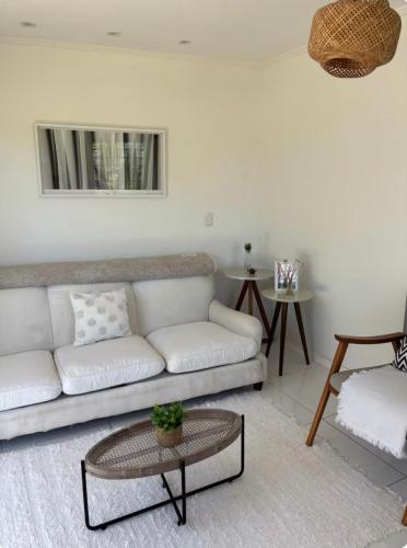 a living room with a couch and a table at Casa de Praia na Barra, Ilhéus in Ilhéus