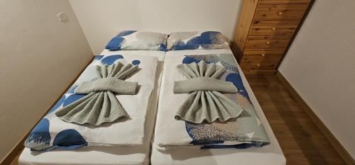 a bed with two pillows on top of it at Sella Nevea Resort in Sella Nevea