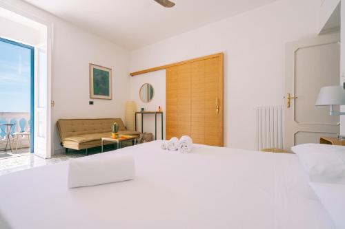 a bedroom with a bed and a living room at Casa Flora in Vietri sul Mare