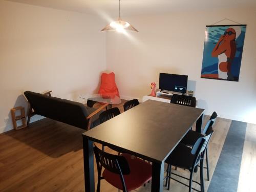 a dining room with a table and chairs at Pors Melenn in Douarnenez