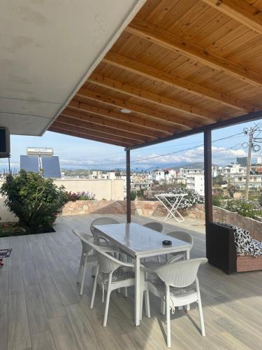 a white table and chairs on a patio with a view at Villa Murataj in Ksamil