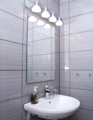 a bathroom with a sink and a mirror at Sure Hotel by Best Western Algen in Östersund