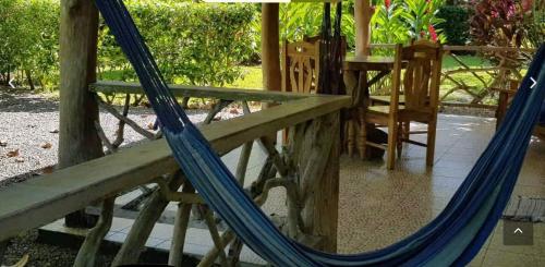 a swing with a blue rope on a porch at Hotel 3 Bamboo Ecolodge in Cahuita