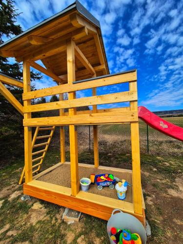 a wooden play house with toys in it at Ubytování nad přehradou in Dvůr Králové nad Labem