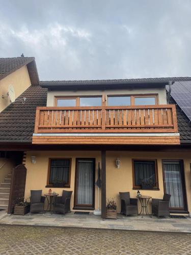 a house with a large deck on top of it at Pension Mien Fründt in Baabe