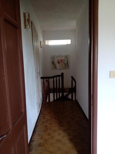 a hallway with a chair and a table in a room at Bed and Breakfast Nicole Ponti in Ponti