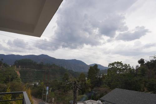 a view of the mountains from a house at Hotel GRP INN City Homes in Pithorāgarh