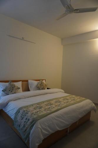 a bedroom with two beds and a ceiling fan at Hotel GRP INN City Homes in Pithorāgarh