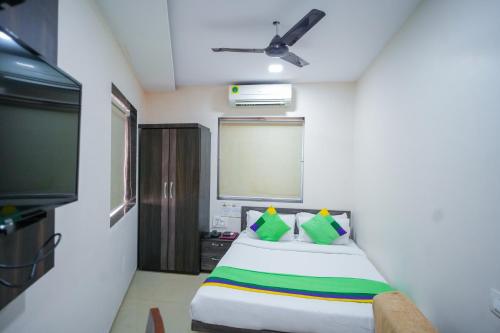 a bedroom with a bed and a flat screen tv at Hotel Skylink Hospitality Mahalaxmi in Mumbai
