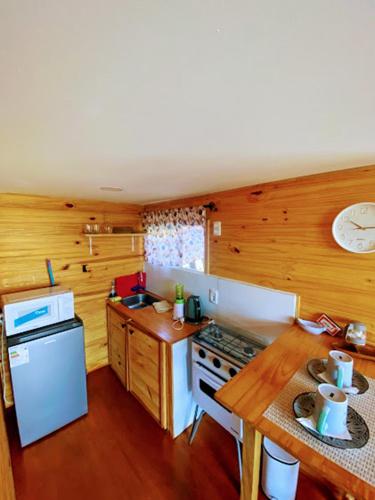 a kitchen with a stove and a counter top at Linda cabaña con excelente vista panorámica in Piriápolis