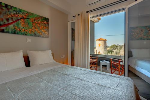 a bedroom with a bed and a balcony with a view at Semeli Art House 2 in EFL