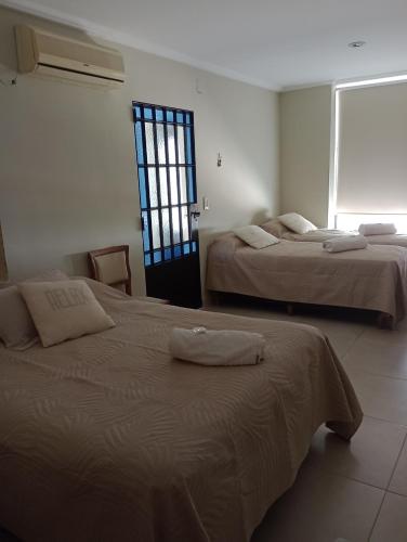 two beds in a room with a window at La rue de Rox ,apart in Corrientes