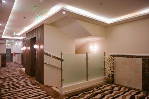 a lobby with a staircase in a building at فندق فيوليت الفندقية Violet Hotel in Yanbu