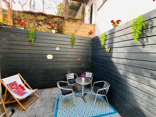 a patio with two chairs and a table and chairs at Kinderparadies Alt Lüxem in Wittlich