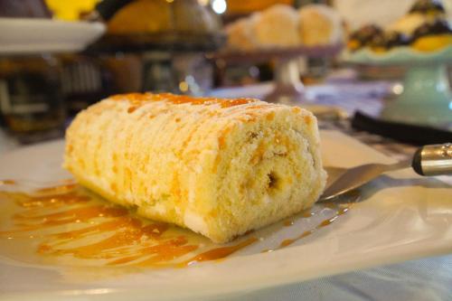 a piece of cake sitting on a white plate at Minha Glória Hotel Boutique in Bom Jardim