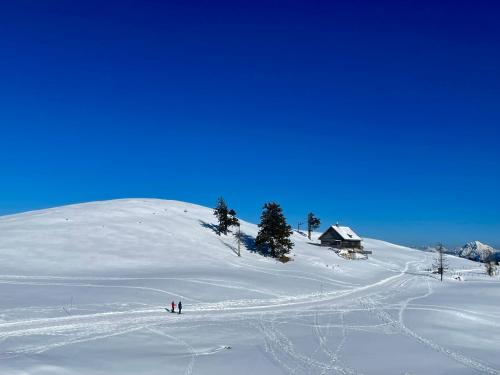 two people standing on a snow covered slope at Sweet Mountain Home in Bad Bleiberg