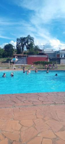 a group of people swimming in a swimming pool at Pousada Hotel Chale Parque Aquatico Lindoia in Lindóia