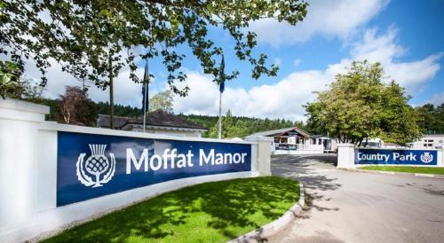 a sign for a motorott marror in a parking lot at Lodge with a stunning view in Beattock