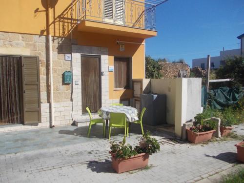 a patio with a table and chairs in front of a building at Soleli in Molino San Biagio