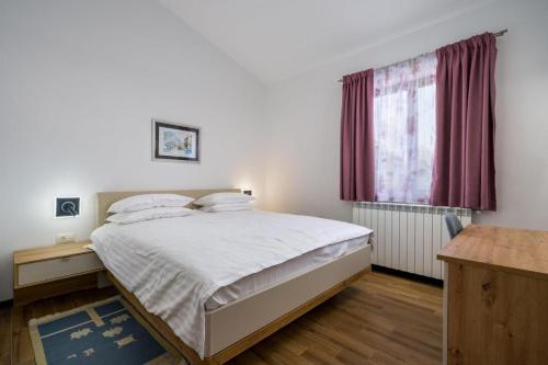 a bedroom with a bed and a window at Holiday house Lera Rovinj, with football field, sauna, jacuzzi in Rovinj