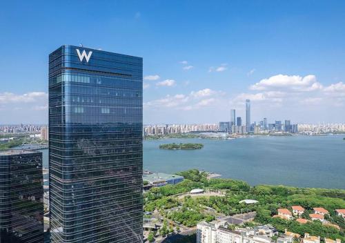 a tall building with a sign on the side of it at W Suzhou - Jinji Lake in Suzhou