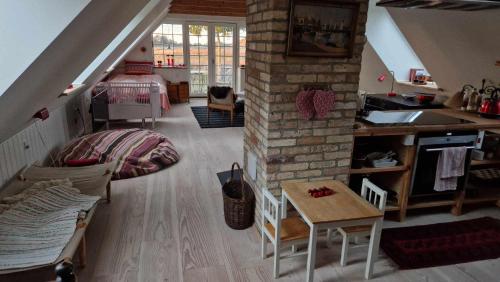 a living room with a staircase and a room with a table at Bakkegaard in Årslev