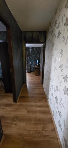 a hallway of a house with wooden floors and wallpapers at Vila Curtea de Arges in Curtea de Argeş
