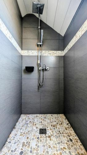 La salle de bains est pourvue d'une douche et de carrelage. dans l'établissement Gîte confortable 12 pers à 15 minutes des plages, à Péaule