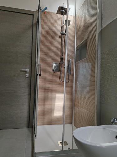 a bathroom with a glass shower and a sink at Casa Aurora apartment near Cagliari in San Sperate