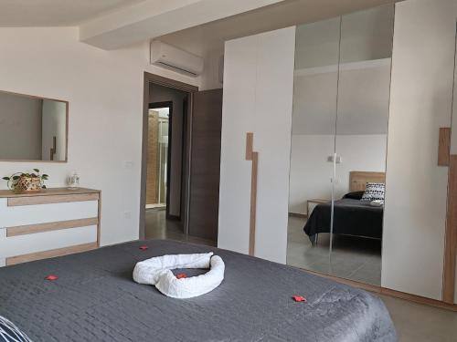 a bedroom with a bed with a large mirror at Casa Aurora apartment near Cagliari in San Sperate