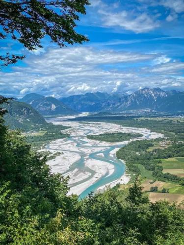 a view of a river with mountains in the background at Appartamento Palazzo Gattolini Venzone in Venzone