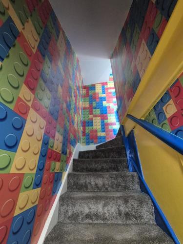 a staircase with a colorful wall and a stair case at The Lego themed house in Windsor