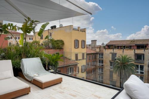 a balcony with chairs and a view of buildings at master Trevi in Rome