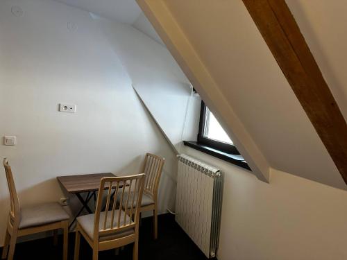 a room with a table and chairs and a window at Konaci 25 Kopaonik in Kopaonik
