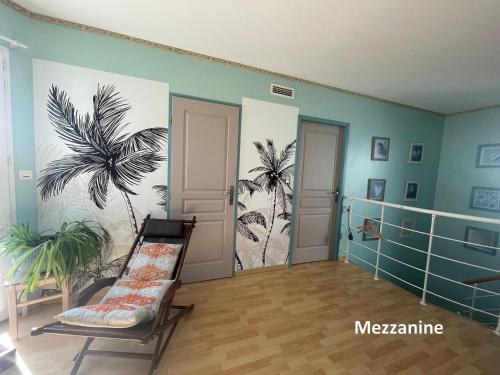 Cette chambre est ornée d'une fresque murale représentant des palmiers. dans l'établissement Jolie villa avec piscine et vue panoramique sur le golf, à La Grande Motte