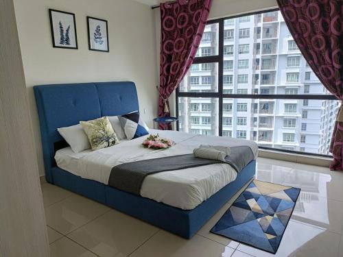 a blue bed in a room with a large window at A-18-09 La Reve SuiteHyveWiFiNETFLIXFreeParking in Cyberjaya
