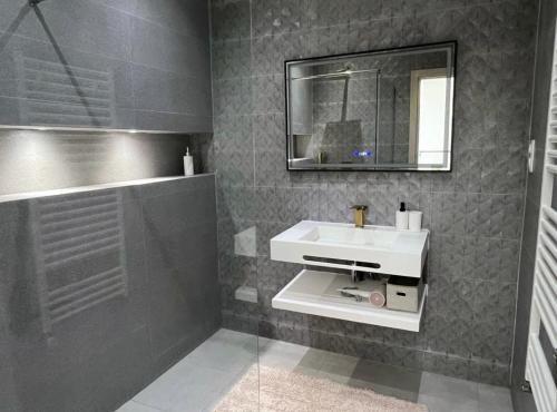 a bathroom with a sink and a mirror and a shower at Villa haut standing avec piscine chauffée sans vis-à-vis et hammam in Ouled Moussa