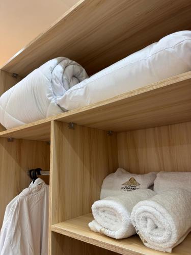 a bunk bed with towels and a mattress at LE Grand Pyramids View & Suites in Cairo