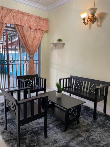 a living room with two chairs and a table at Aisyah Homestay NEAR A FAMOSA TAMPIN in Kampong Pulau Sebang
