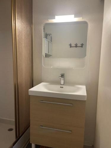 une salle de bain avec un lavabo blanc et un miroir dans l'établissement Studio cabine, plage de St Cyprien, 200 m de la mer, à Saint Cyprien Plage
