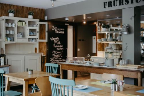 a restaurant with tables and chairs and a counter at Das Esel - Kleinod in Rust in Rust