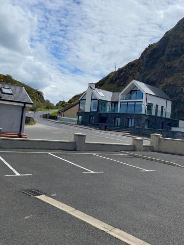 a parking lot with a building on the side of a mountain at Seacoast View in Limavady
