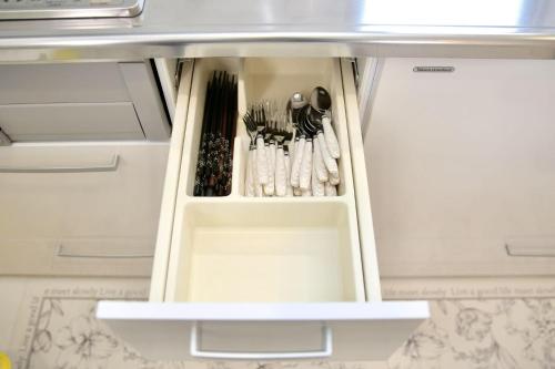 an open refrigerator drawer with utensils in it at NewOpen大石100A広い展望台, 富士山と河口湖を望む 近大石公園 in Fujikawaguchiko