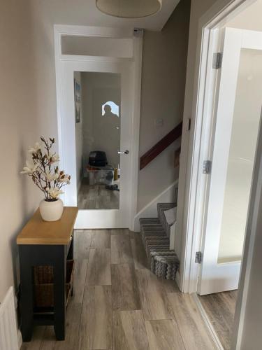 a hallway with a staircase and a door with a plant at Seacoast View in Limavady