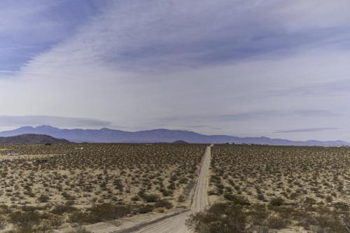 an empty road in the middle of the desert at Loma Vista By The Cohost Company in Sunfair Heights