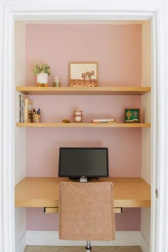 a computer monitor sitting on top of a wooden desk at Loma Vista By The Cohost Company in Sunfair Heights