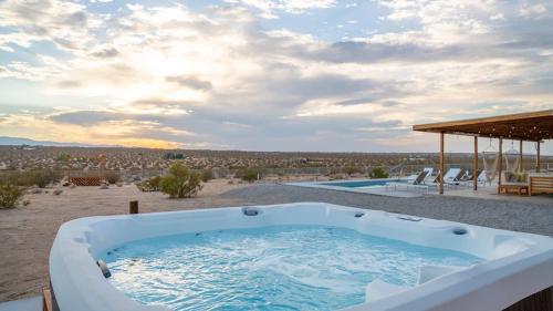 a hot tub on a patio with a view at Loma Vista By The Cohost Company in Sunfair Heights